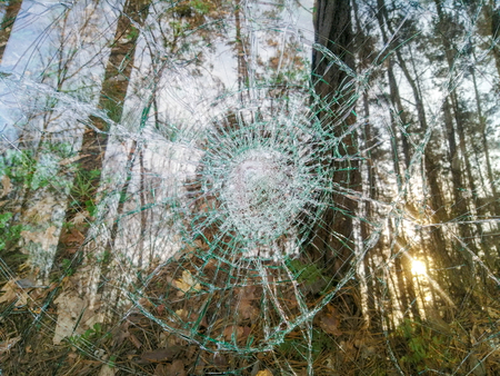 Holes and cracks on the glass On defocused background close upの写真素材