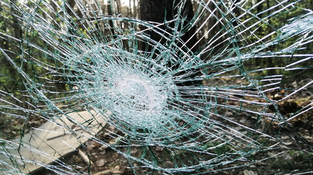 Holes and cracks on the glass On defocused background close upの写真素材