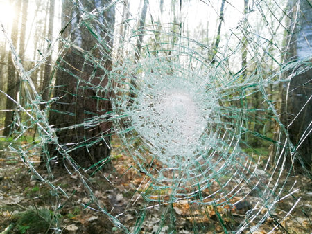 Holes and cracks on the glass On defocused background close up
