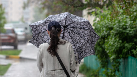 May 7, 2019 Ukraine Bucha. Rainy weather on the streets of the city People hide from rain under...