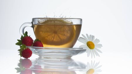 cup of herbal tea with chamomile flowers on a wooden tableの写真素材