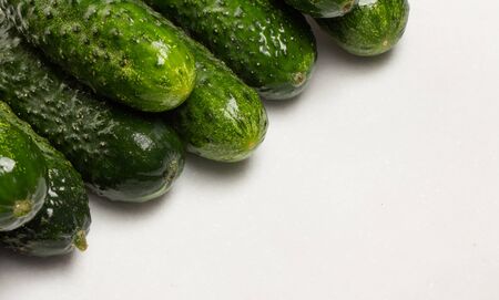 Beautiful young cucumbers on a white background close upの写真素材