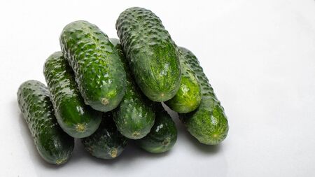 Beautiful young cucumbers on a white background close upの写真素材