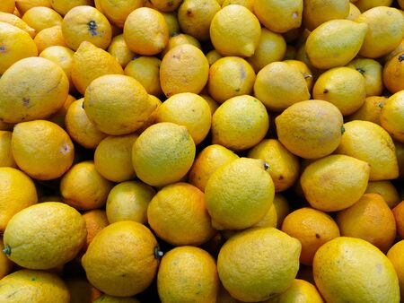 Fresh lemons on the store shelf texture backgroundの写真素材