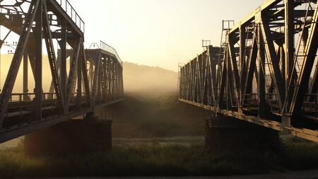 Double railway bridge over river in morning fogの写真素材