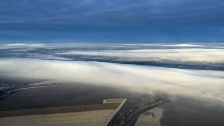 Fog waves the empty fields. Autumn skyの写真素材