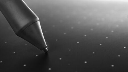 Graphic tablet pen on the surface of the device, close-up photo.の写真素材