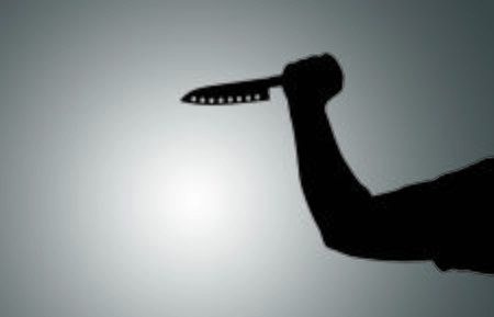 Shadow in the form of hands with a knife on a white backgroundの写真素材