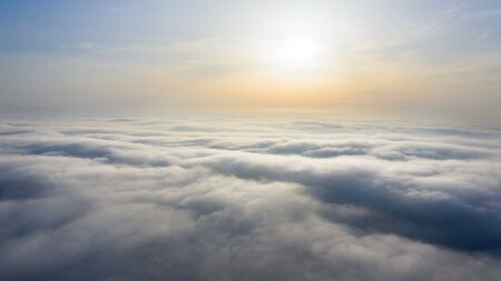 Yellow and blue dawn over clouds, concept, travel and leisure.の写真素材