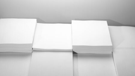Several stacks of white paper on a white backgroundの写真素材