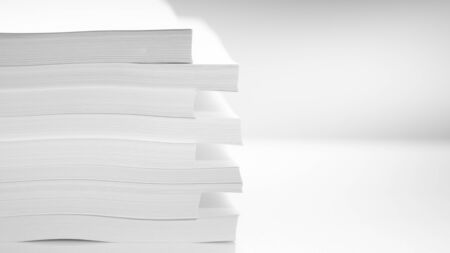 Several stacks of white paper on a white backgroundの写真素材