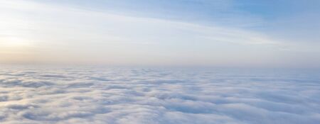 Yellow and blue dawn over clouds, concept, travel and leisure.の写真素材