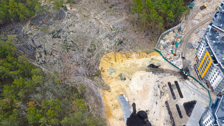 Construction of multi-storey residential buildings in the forest, destruction of nature due to the...