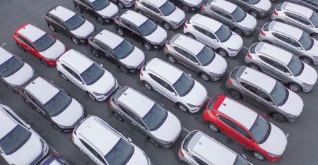 Drone view, new car parking, near the car dealer's logistics center. The parking lot of the updated...