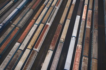 Aerial view of the many-lane railway junction with trains, passengers and freight wagons. Wagon depot.の写真素材