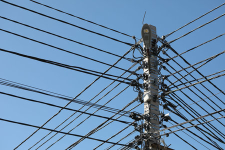Concrete pillar of the power line, with lots of internet, electricity and other communications,...