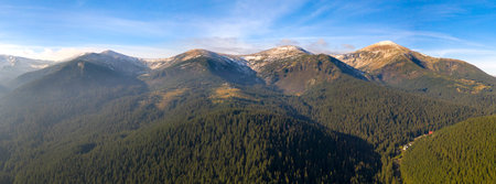 Wonderful dawn in the mountains, the sun's rays illuminate the mountain tops through the fog.
