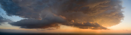 Sunrise or sunset. Summer landscape. The sun's rays shine through the storm clouds.