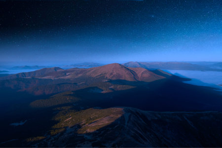 View from Hoverla, on the starry sky over the peaks of the Carpathians.