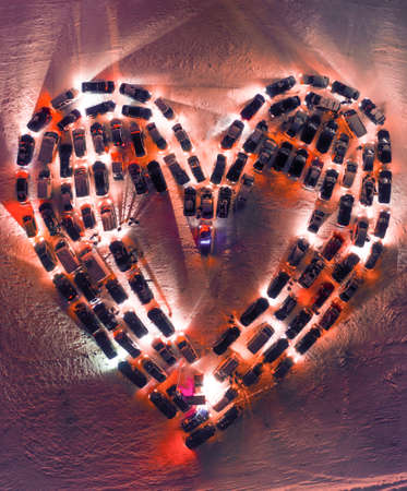 Love concept and valentines day. Cars parked in the shape of a heart in the parking lot. Aerial view.の写真素材
