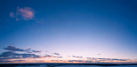 Dawn above the clouds, purple sunlight illuminates the morning sky.の写真素材