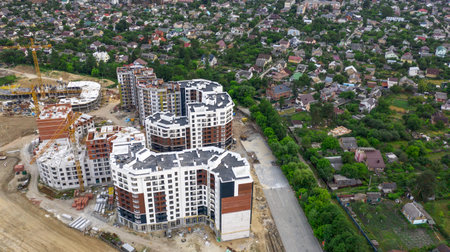 View from the drone on the high-rise buildings being built next to the cottages.