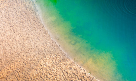 Clean sandy beach and turquoise water drone view