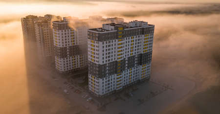 High-rise skyscrapers, sunlight and morning fog. aerialの写真素材