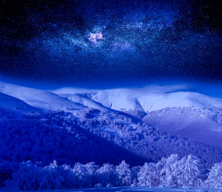 night sky over the snow capped mountain.の写真素材
