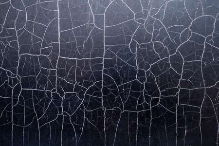 Many chaotic cracks on the surface of the textured material.の写真素材