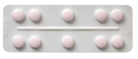 Plate with white pills isolated on a white backgroundの写真素材