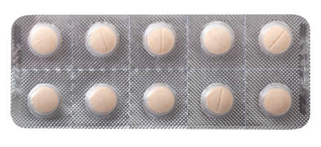 pink pills in a silver opaque plate isolated on a white background.の写真素材