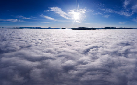 Dawn over clouds in the mountains, aerial view.