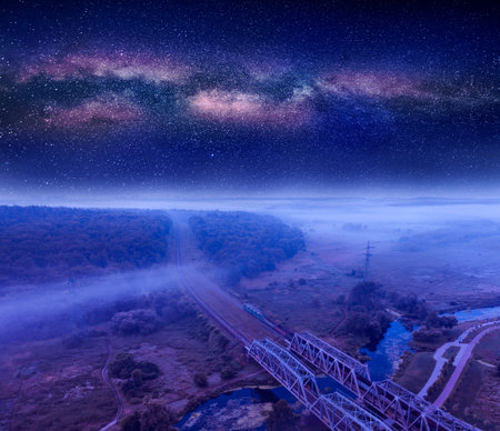 Summer night landscape, railway through the forest. Starry sky.の写真素材