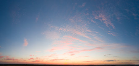 Sunrise or sunset. Summer landscape. The sun's rays shine through the storm clouds.