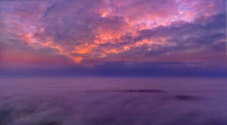 Panorama of the morning blue sky, illuminated by orange and red sunlight, colorful dawn.の写真素材