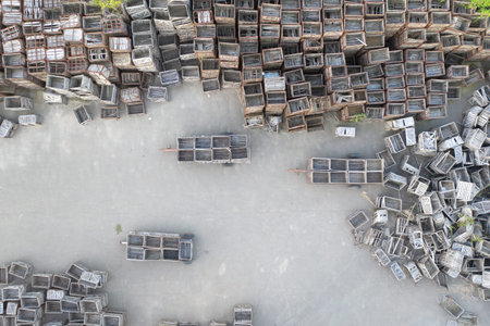 Lots of wooden boxes on the asphalt site. Aerial view.