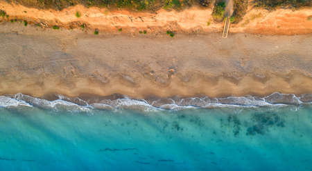 Empty tropical wild beach, light sand and blue clear water. Aerial view.の写真素材