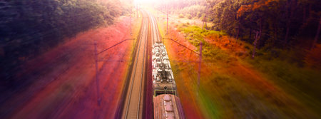 Dawn over the forest through which the railway line runs. Wonderful summer bright landscape.の写真素材