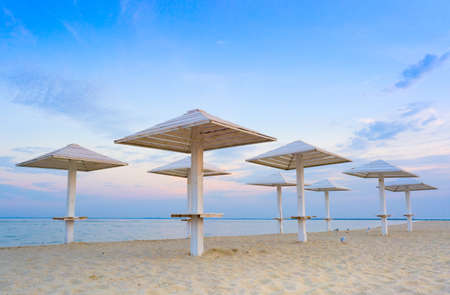 Empty clean beach on the Adriatic sea Wooden umbrellas for sun protection.の写真素材