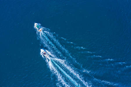Holidays at sea. Two high-speed yachts, drone view. Walks on the sea, rent of sea vessels.の写真素材