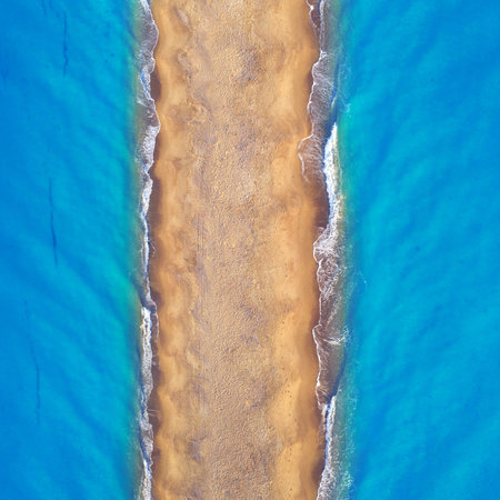 Empty tropical wild beach, light sand and blue clear water. Aerial view.の写真素材