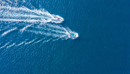 Holidays at sea. Two high-speed yachts, drone view. Walks on the sea, rent of sea vessels.の写真素材