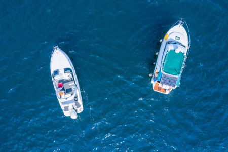 Holidays at sea. Two high-speed yachts, drone view. Walks on the sea, rent of sea vessels.の写真素材