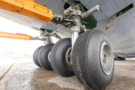 Worn cargo plane chassis. Damaged rubber tire as a result of prolonged use.