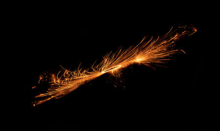 Circle with sparks, sparkler, cotton wool or fireworks on a black background.の写真素材