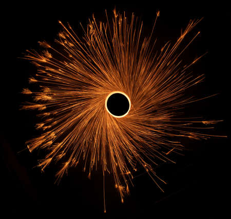 Circle with sparks, sparkler, cotton wool or fireworks on a black background.の写真素材
