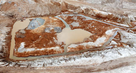 Red toxic water in the tank of the mining and processing plant.の写真素材