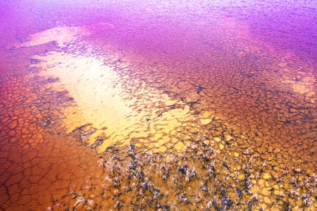 Red toxic water in the tank of the mining and processing plant.の写真素材