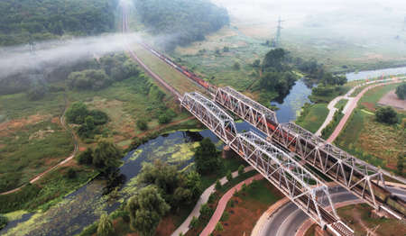 Two railway bridges across the river at dawn.の写真素材